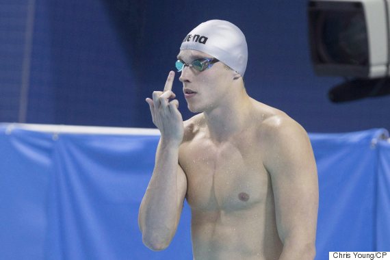 Santo Condorelli performs his customary salute to his father before the start of the 50m men's freestyle during the finals of the Canadian Olympic swimming trials in Toronto on Sunday, April 10, 2016. Just to be clear, Condorelli isn't giving you the finger from the start blocks. He's giving it to his father. THE CANADIAN PRESS/Chris Young